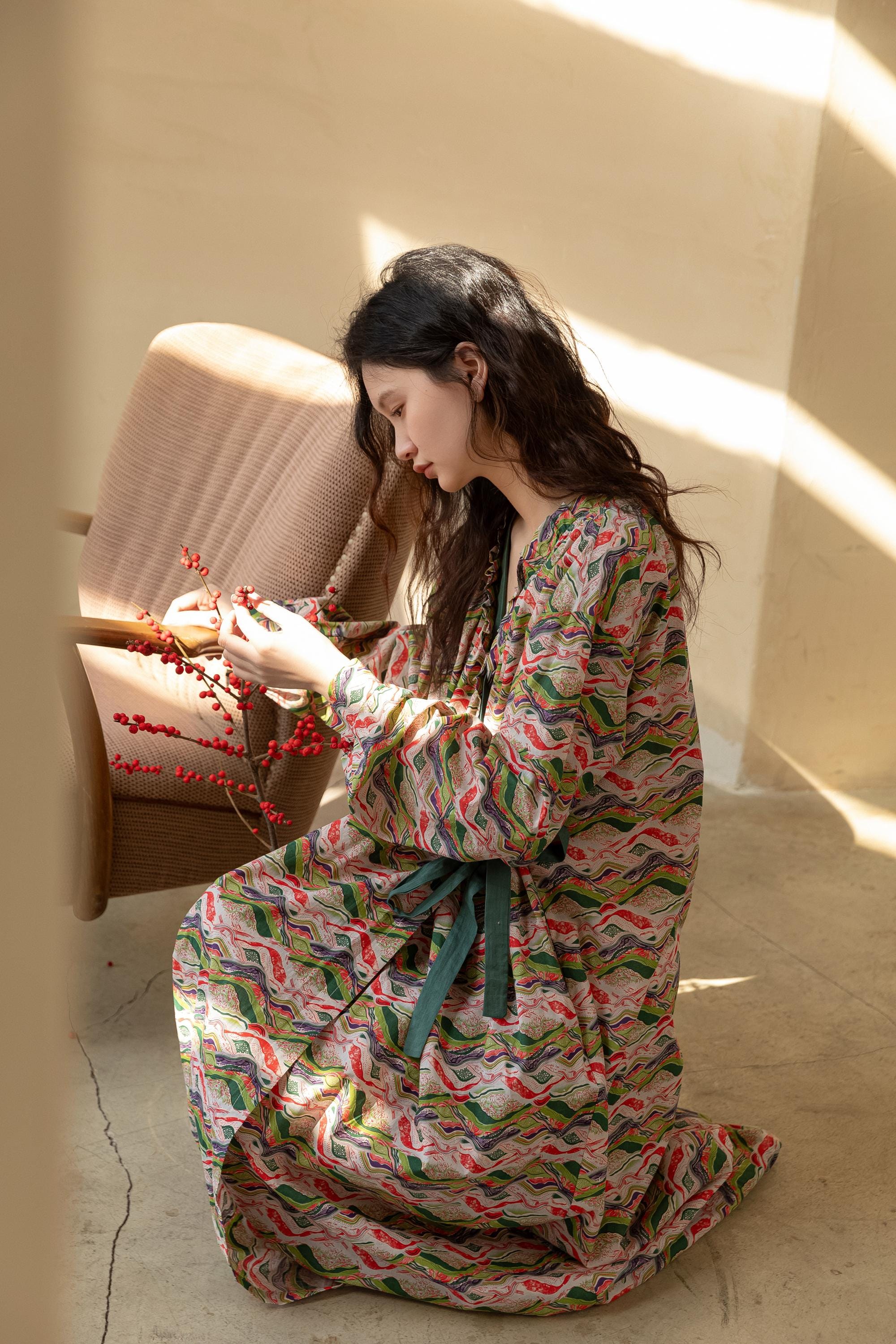 Model wearing an elegant bamboo cotton robe with oriental patterns, featuring a relaxed fit and a green sash, perfect for loungewear and home comfort