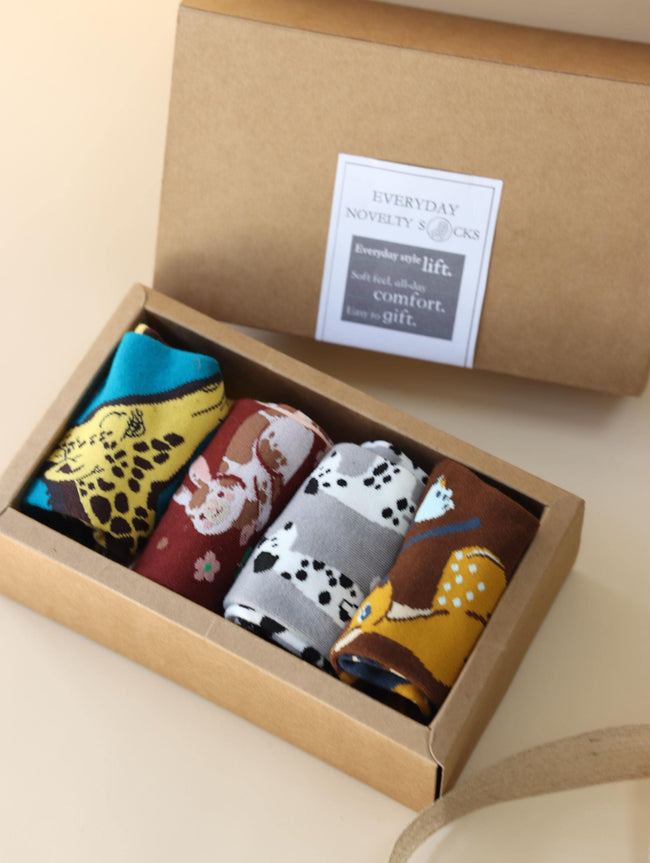 Cotton blend funny socks by Lian Loungewear with animal and graphic mismatched designs in a gift box set.