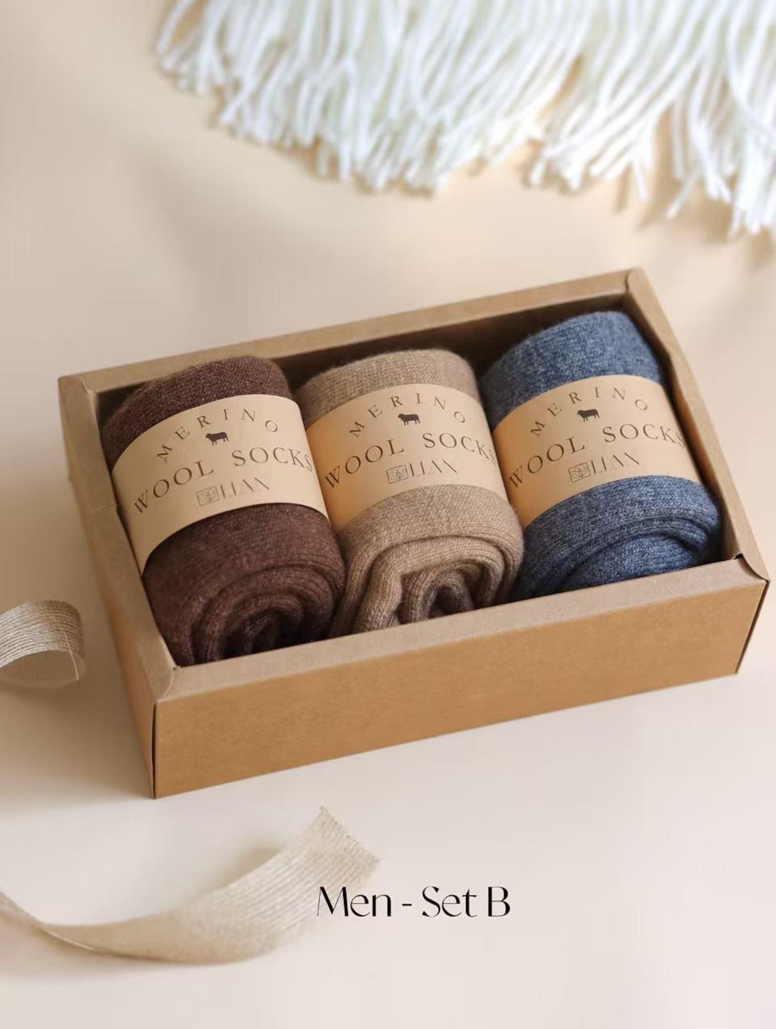Three pairs of Lian Loungewear 98% Merino Wool Socks in a gift box, cozy and comfortable for cold weather.