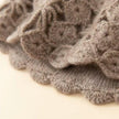 Ivory cream hand-knit cashmere-wool beanie with crochet lace, warm winter cap by Lian Loungewear, cozy and stylish headwear.