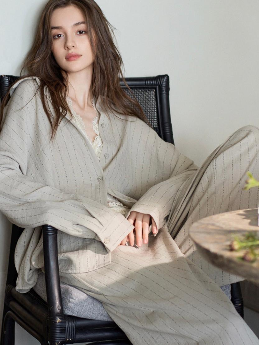 Beige cotton women's loungewear set with button-down pajama top and matching pants, comfortable and casual lounge outfit.
