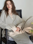 Beige cotton women's loungewear set with button-down pajama top and matching pants, comfortable and casual lounge outfit.