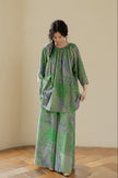Green bamboo cotton loungewear set by Lian Loungewear with botanical print and oversized fit, featuring relaxed pants and top.